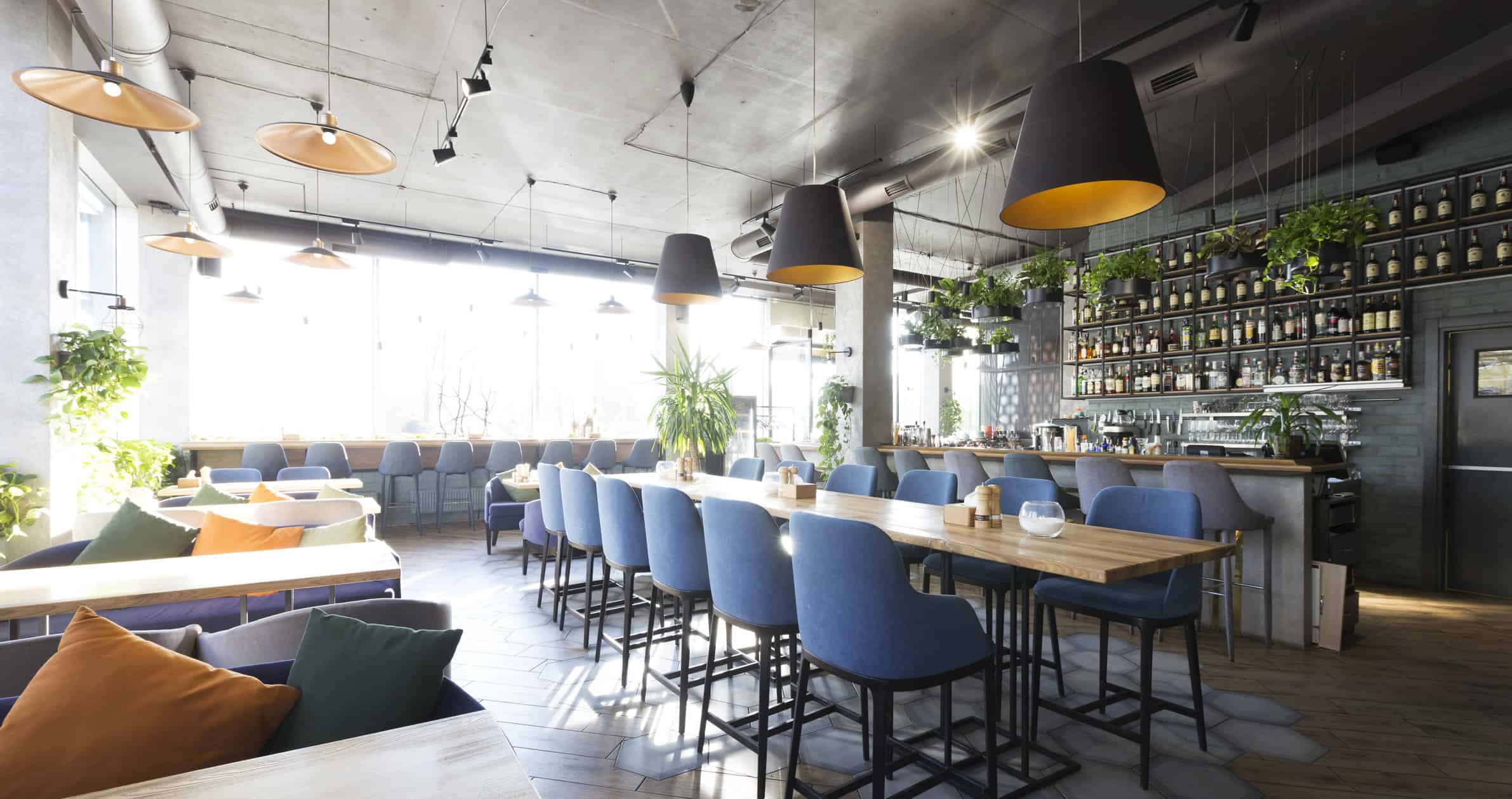 Modern Restaurant Interior Painting Modern commercial restaurant interior with blue upholstered bar seating, black pendant lights with gold accents, and painted