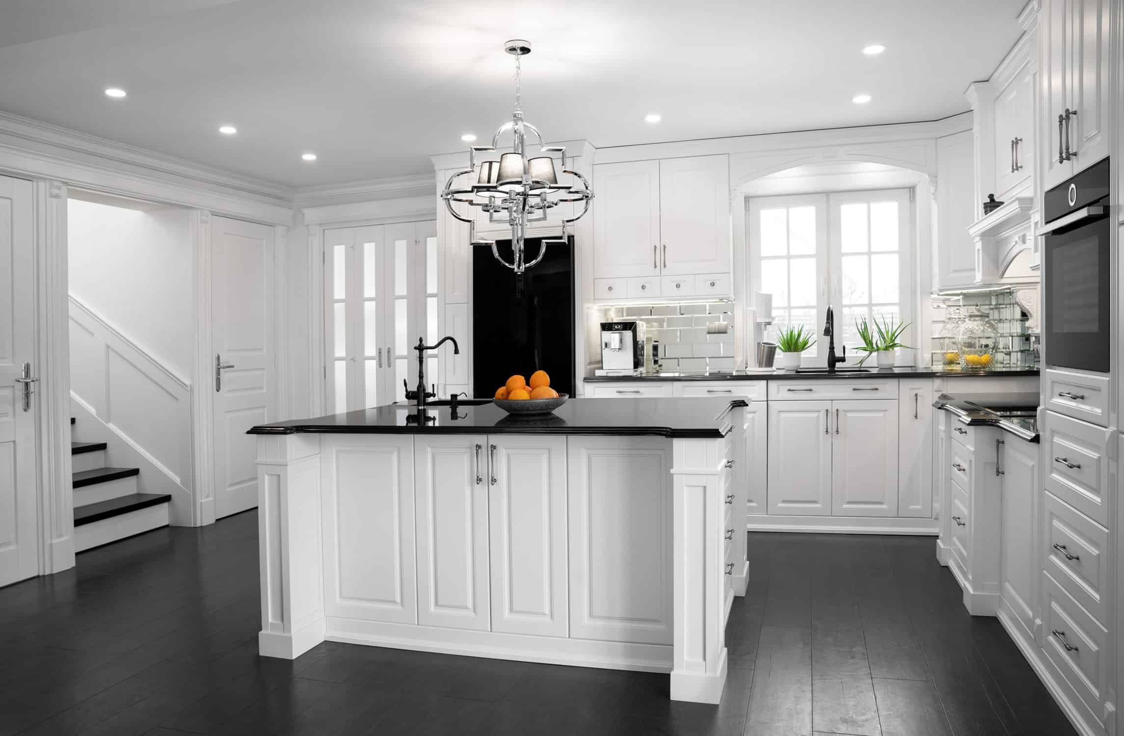 beautiful white kitchen with large island black countertop