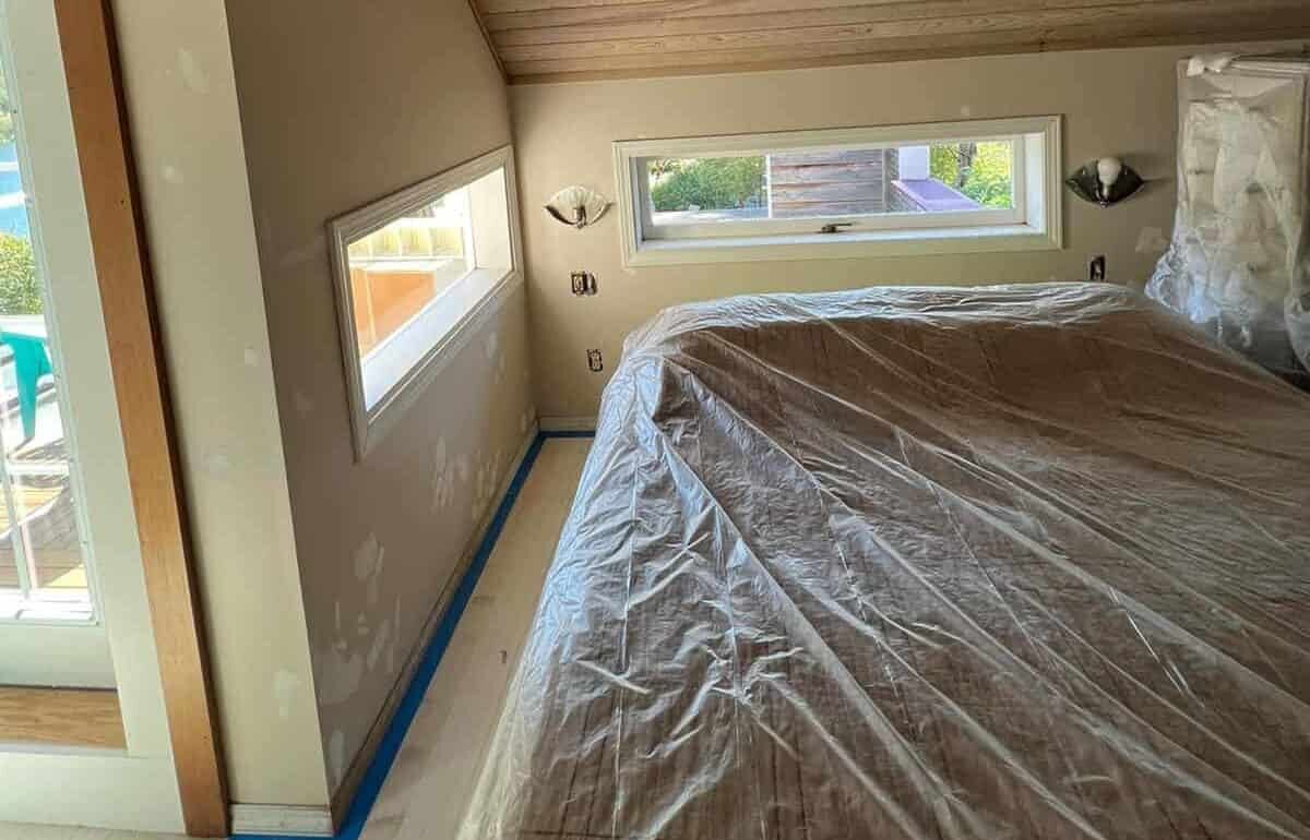 bed covered in plastic cover and trims in painter’s tape.jpg Ways to Protect Furniture